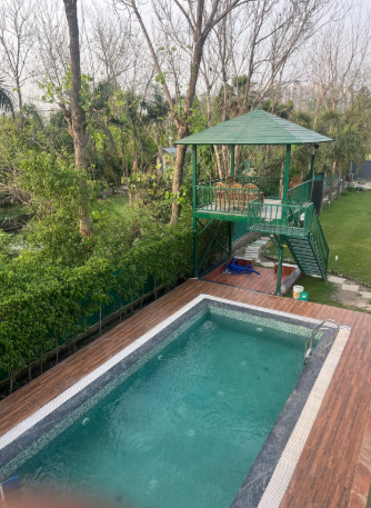 Private swimming pool and elevated gazebo at Expostay Farm Noida